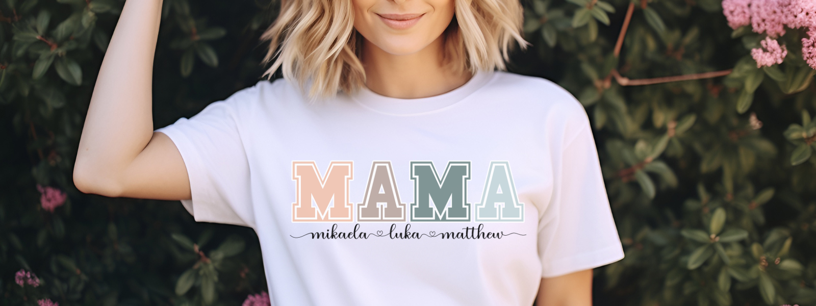 Woman smiling wearing a personalized custom Mama shirt she received as a gift